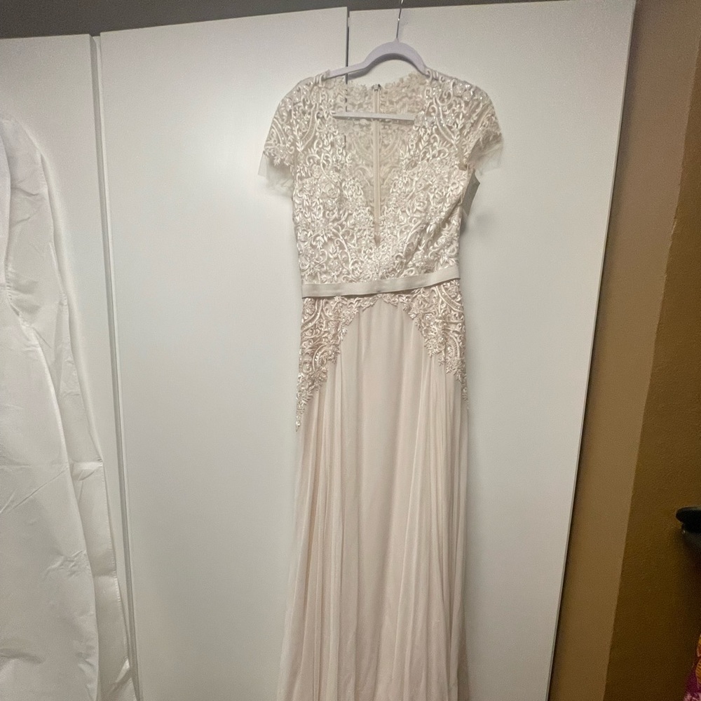 Never altered, never worn Reem Acra wedding dress. Size 12. Tags still on.